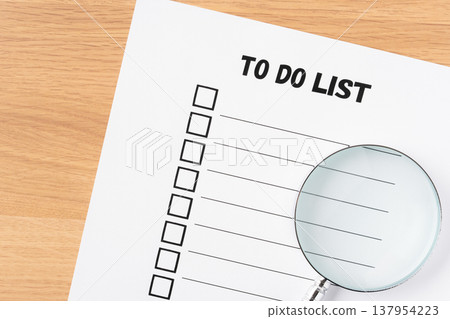To-do list paper and magnifying glass 137954223