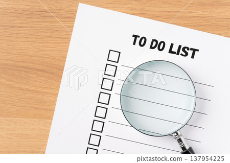 To-do list paper and magnifying glass 137954225