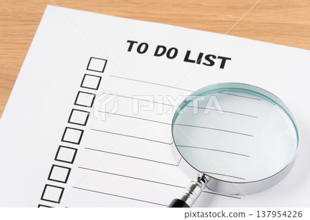 To-do list paper and magnifying glass 137954226