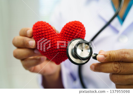 Asian woman doctor holding red heart for health in hospital. Asian woman doctor holding red heart for health in hospital. 137955098