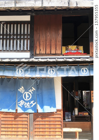 Hina dolls placed in the second floor window facing the street 137955355