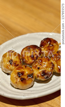 Chicken meatballs on a skewer coated in a sweet and savory sauce Chicken meatballs on a skewer coated in a sweet and savory sauce 137955573