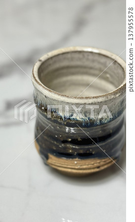A beautiful Korean-style teacup with a textured glaze. 137955578