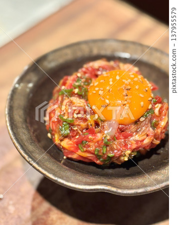 Yukhoe served with egg yolk and sesame seeds Yukhoe served with egg yolk and sesame seeds 137955579