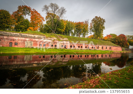 Old brick wall of Fort 5 King Frederick William III by moat in Kaliningrad. Russia Old brick wall of Fort 5 King Frederick William III by moat in Kaliningrad. Russia 137955655