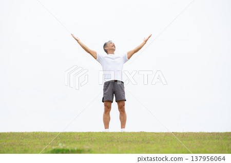 A man stretching on the bank 137956064