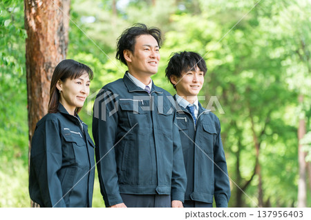 Male and female workers in forestry and civil engineering work clothes in the forest Male and female workers in forestry and civil engineering work clothes in the forest 137956403