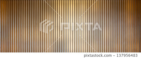 Vertical lines of wooden louvers and a gradient of light (abstract background) - an abstractly represented background material. Vertical lines of wooden louvers and a gradient of light (abstract background) - an abstractly represented background material. 137956483