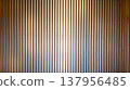 Vertical lines of wooden louvers and a gradient of light (abstract background) - an abstractly represented background material. 137956485