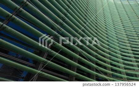 Reflections and geometric patterns on the glass facade (abstract urban background material) - an abstract capture of the exterior of glass architecture. Reflections and geometric patterns on the glass facade (abstract urban background material) - an abstract capture of the exterior of glass architecture. 137956524