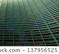 Reflections and geometric patterns on the glass facade (abstract urban background material) - an abstract capture of the exterior of glass architecture. 137956525