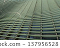 Reflections and geometric patterns on the glass facade (abstract urban background material) - an abstract capture of the exterior of glass architecture. 137956528