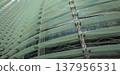Reflections and geometric patterns on the glass facade (abstract urban background material) - an abstract capture of the exterior of glass architecture. 137956531
