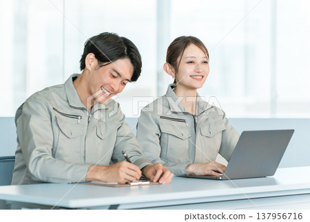 Male and female staff in work clothes conducting interviews, meetings, and consultations in a conference room. Male and female staff in work clothes conducting interviews, meetings, and consultations in a conference room. 137956716