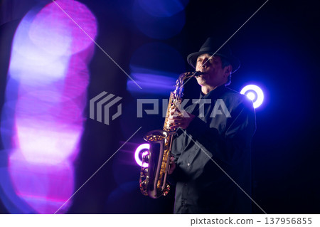 Man playing the saxophone live 137956855