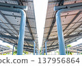 Aerial view of solar panels installed as shade canopy over parking lot with parked cars to generate electricity, photovoltaic technology. 137956864
