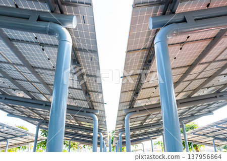 Aerial view of solar panels installed as shade canopy over parking lot with parked cars to generate electricity, photovoltaic technology. Aerial view of solar panels installed as shade canopy over parking lot with parked cars to generate electricity, photovoltaic technology. 137956864