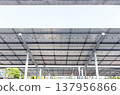 Aerial view of solar panels installed as shade canopy over parking lot with parked cars to generate electricity, photovoltaic technology 137956866