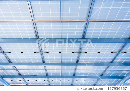 Aerial view of solar panels installed as shade canopy over parking lot with parked cars to generate electricity, photovoltaic technology 137956867
