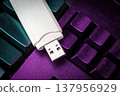USB flash drive lying on black keyboard. Virtual memory storage with USB output 137956929