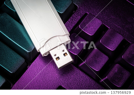 USB flash drive lying on black keyboard. Virtual memory storage with USB output 137956929