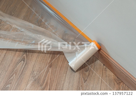 Protective Plastic Sheeting on Wooden Floor Protective Plastic Sheeting on Wooden Floor 137957122