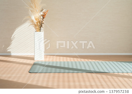 A yoga mat and dried flowers placed in the living room A yoga mat and dried flowers placed in the living room 137957238