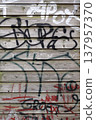 A wooden wall with graffiti 137957370