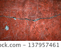 A crack in a red wall 137957461