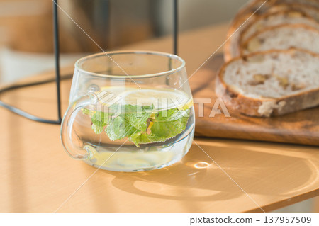 Flavored water, lemon water, and light snacks (bread) are on the table. Flavored water, lemon water, and light snacks (bread) are on the table. 137957509