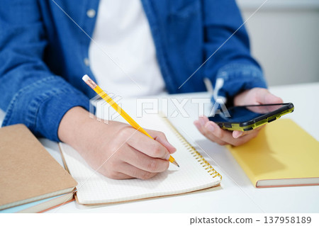 Teenage using smart phone for communication, search data internet website to learn. Teenage using smart phone for communication, search data internet website to learn. 137958189