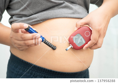 Asian woman injecting herself diabetes injecting insulin in stomach at home. Asian woman injecting herself diabetes injecting insulin in stomach at home. 137958288