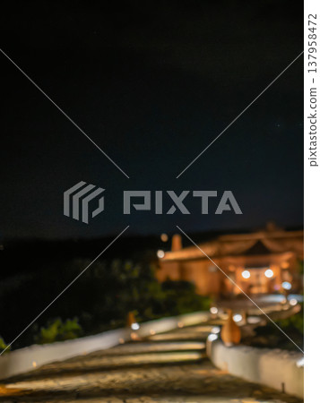 Image of a resort hotel at night and illuminated roads. Image of a resort hotel at night and illuminated roads. 137958472