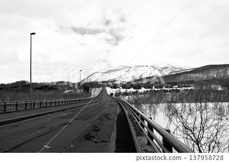 Niseko Annupuri, shrouded in snow clouds, as seen from the St. Moritz Bridge (black and white) Niseko Annupuri, shrouded in snow clouds, as seen from the St. Moritz Bridge (black and white) 137958728