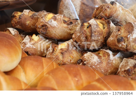 Freshly baked bread lined up in the bakery early in the morning Freshly baked bread lined up in the bakery early in the morning 137958964