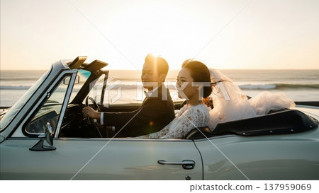 Wedding - Asian Couple in Classic Convertible Car at Sunset Beach Bride in Lace Dress and Groom in Tuxedo 137959069