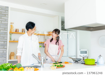 Young couple cooking in the kitchen Young couple cooking in the kitchen 137961248