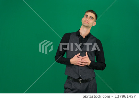 emotions of a handsome man guy on a green background chromakey close-up dark hair young man emotions of a handsome man guy on a green background chromakey close-up dark hair young man 137961457