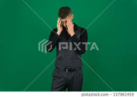 emotions of a handsome man guy on a green background chromakey close-up dark hair young man emotions of a handsome man guy on a green background chromakey close-up dark hair young man 137961459