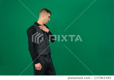 emotions of a handsome man guy on a green background chromakey close-up dark hair young man emotions of a handsome man guy on a green background chromakey close-up dark hair young man 137961485