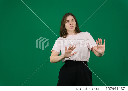 different emotions of a young girl on a green background chromakey beautiful facial features real people pink T-shirt white skinned European. black flared wide leg trousers different emotions of a young girl on a green background chromakey beautiful facial features real people pink T-shirt white skinned European. black flared wide leg trousers 137961487