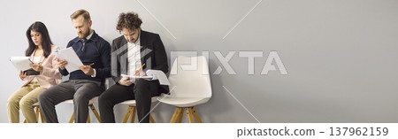 Job interview candidates waiting with resumes, business hiring concept, copy space Job interview candidates waiting with resumes, business hiring concept, copy space 137962159