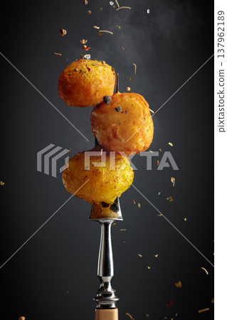 Roasted potatoes sprinkled with a mixture of herbs and spices. 137962189