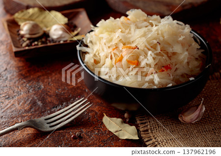 Sauerkraut with ingredients on a rustic background. Sauerkraut with ingredients on a rustic background. 137962196