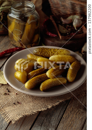 Homemade canned gherkins on a rustic wooden background. 137962200