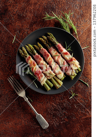 Grilled green asparagus wrapped in bacon. Grilled green asparagus wrapped in bacon. 137962208