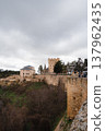 A historic stone fortress standing on a hill 137962435