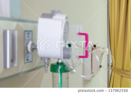 Close up of hospital oxygen flow meter and medical gas outlet showing healthcare environment safety treatment and clinical care concept 137962588