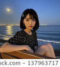 Woman sitting by the sea 137963717