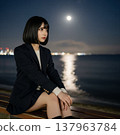 Woman sitting by the sea 137963784